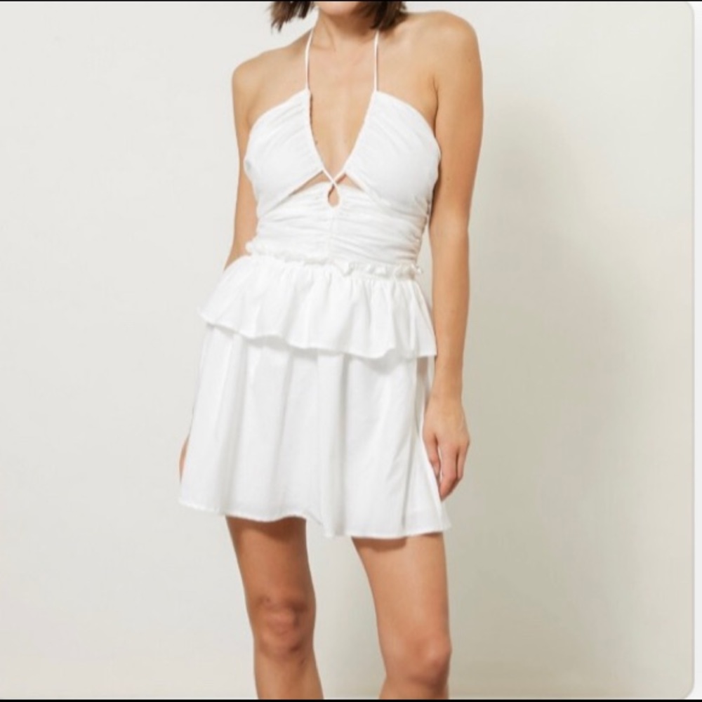 Tiered skirt mini dress with ruched cut-out detail.